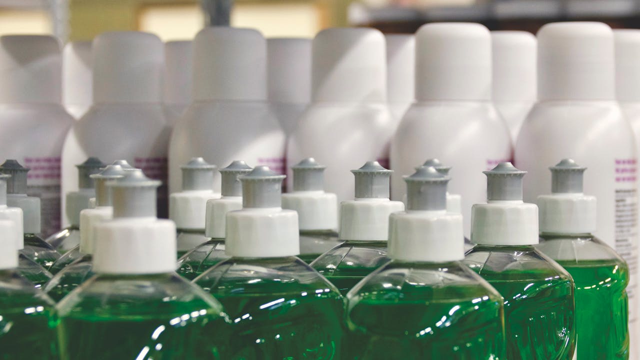 about-01 Close-up view of green liquid in bottles, ideal for household cleaning and stocks.